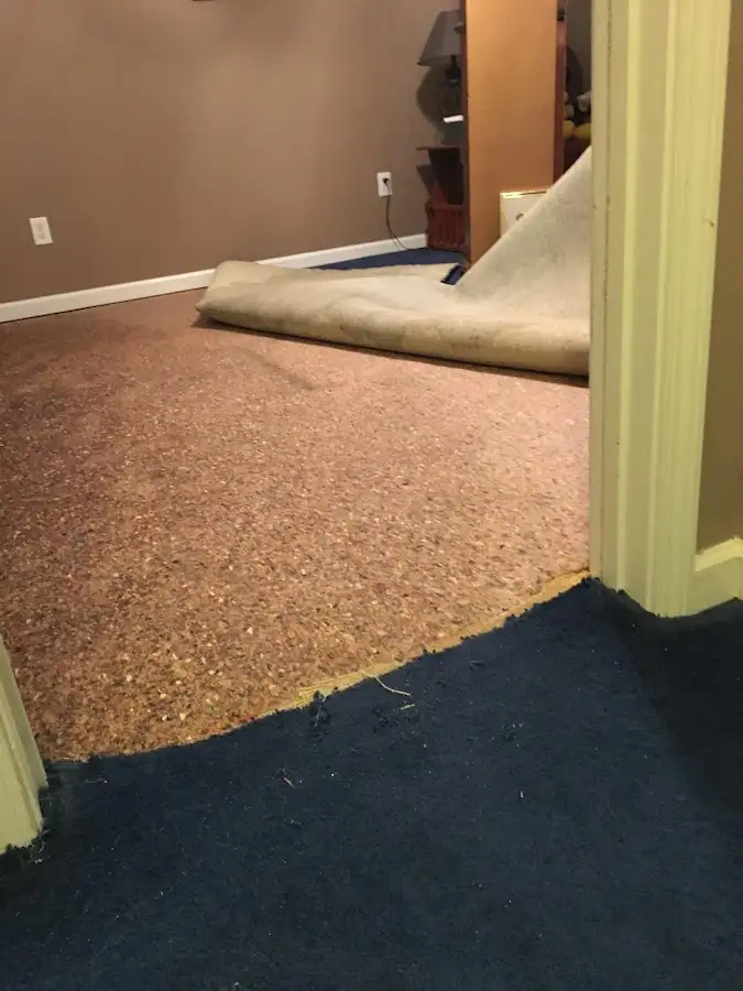 Carpet pad removal revealing water damage during Drying & Dehumidification in Upper